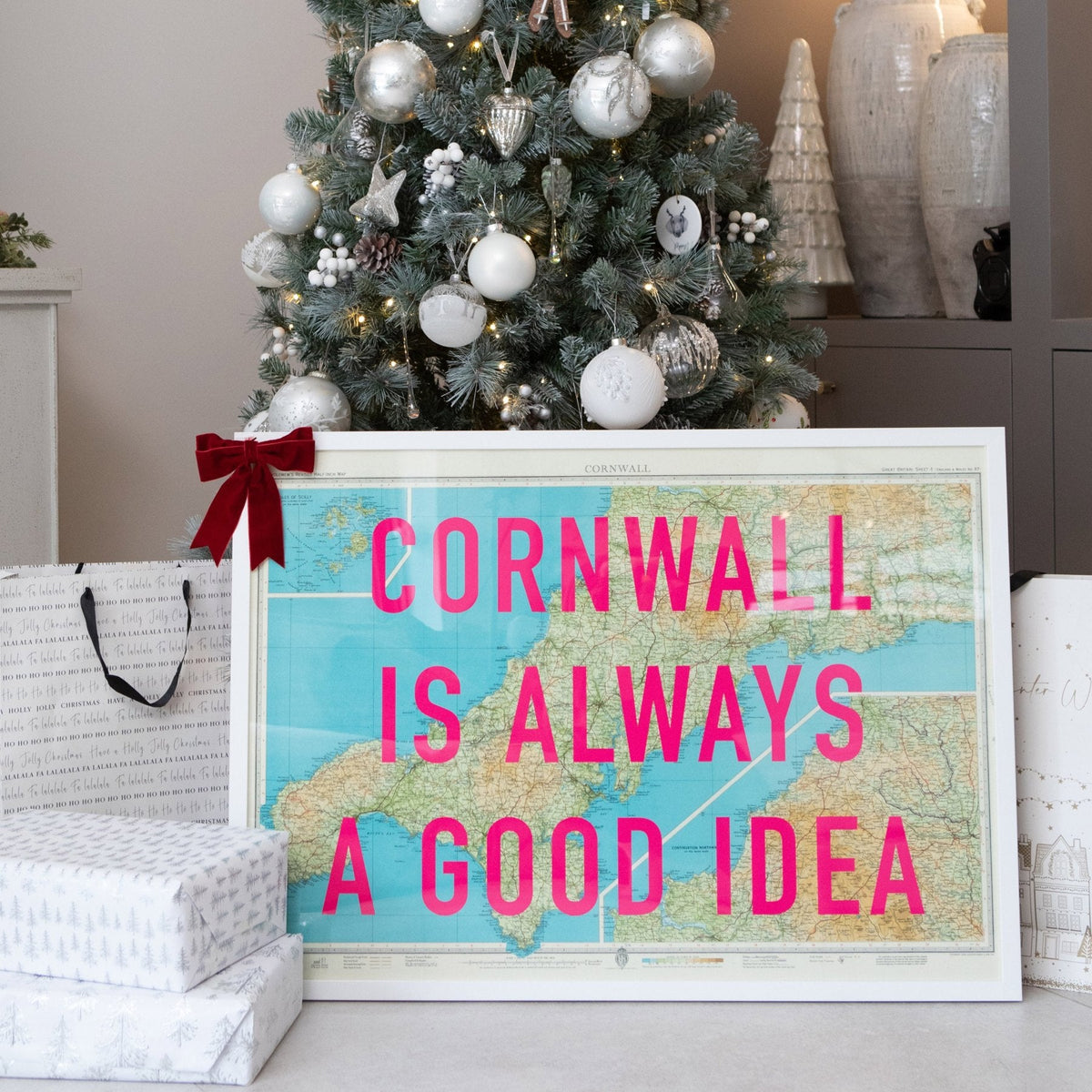A Cornwall pop art map print wrapped with a bow as a Christmas gift