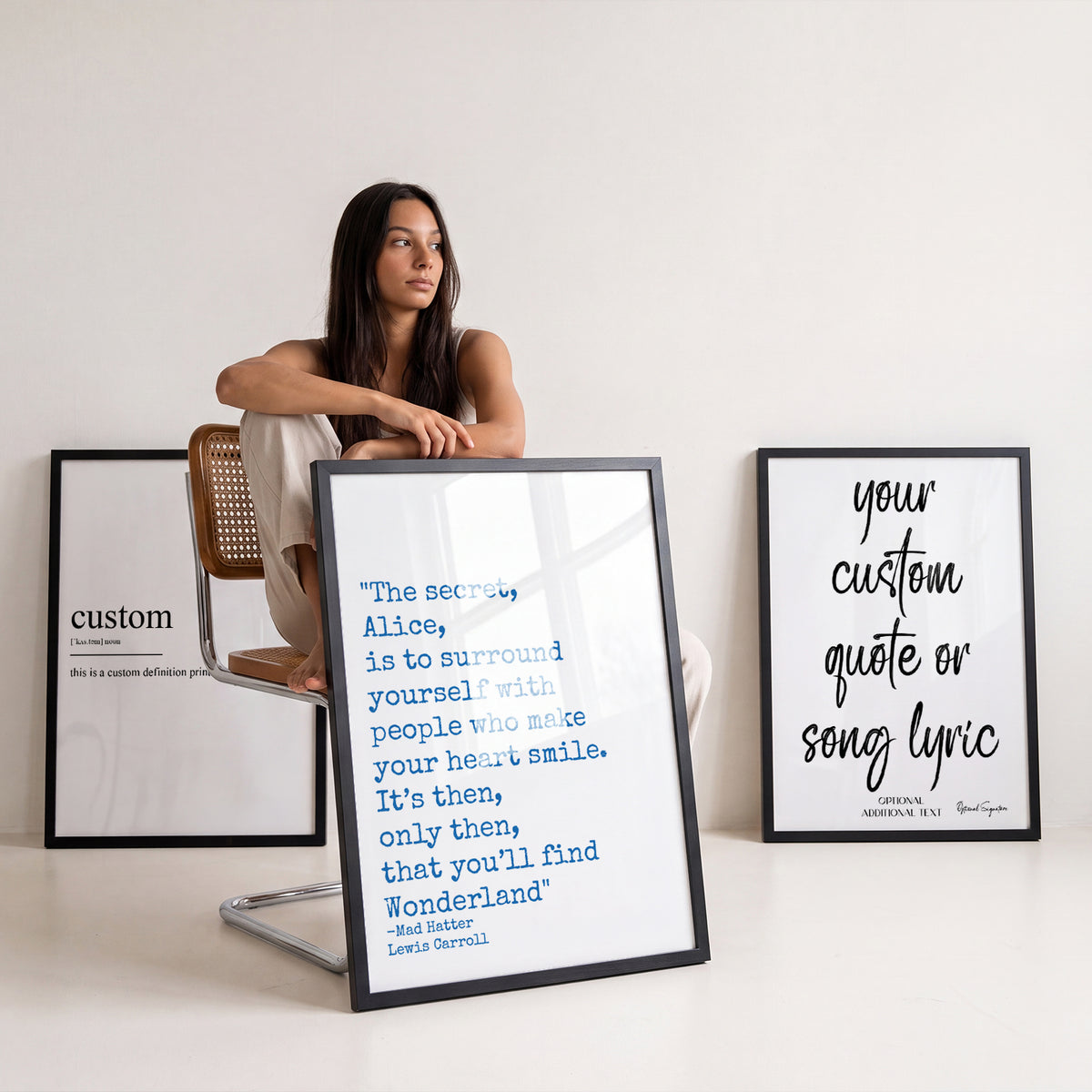 Woman sitting among framed personalised custom text and quote prints