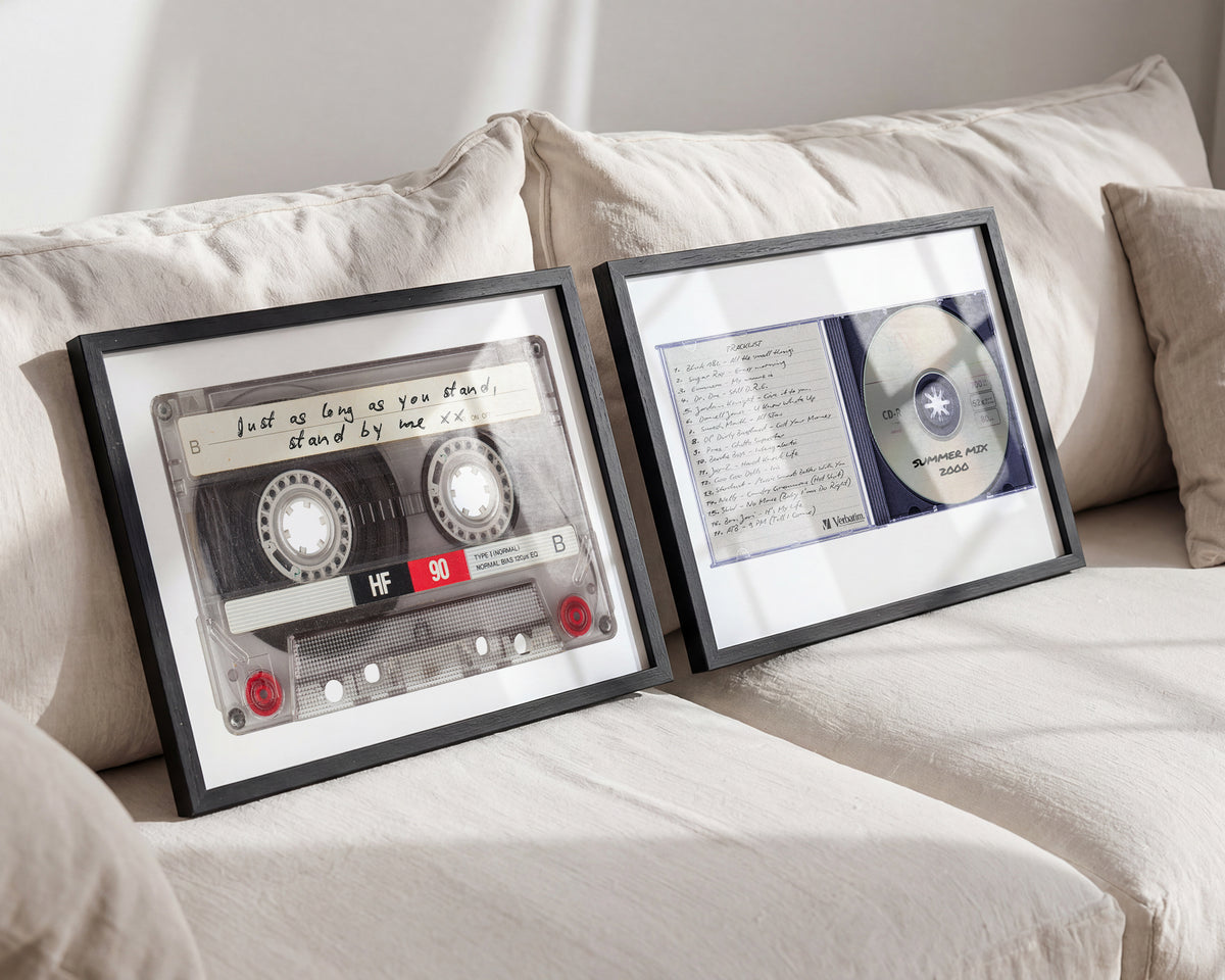 Framed personalised retro mixtape cassette print and CD print displayed on a cream sofa